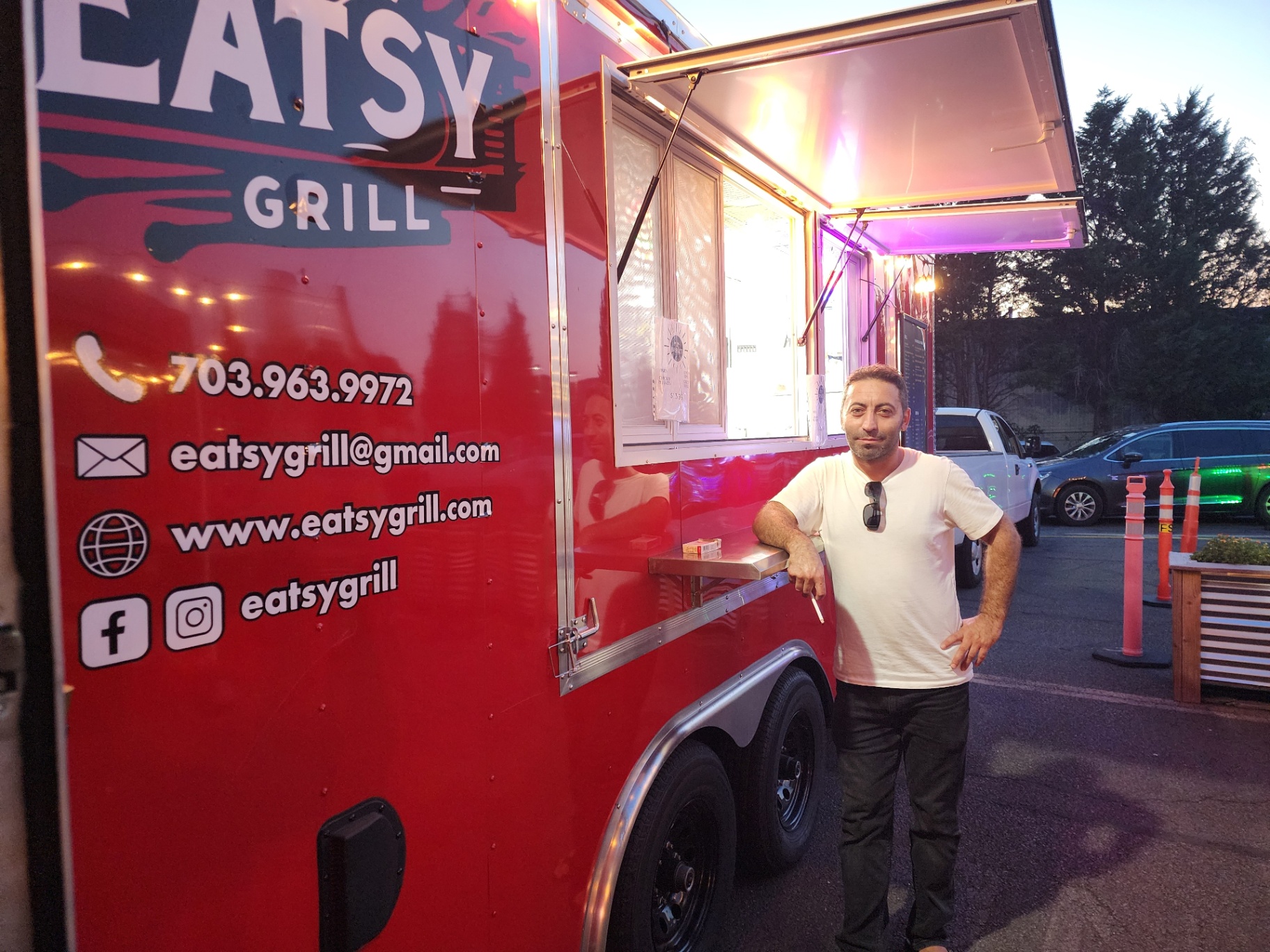 Eatsy Grill red trailer at night with premium branded food imagery
